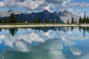 picturesque mountains are reflected in the water in Seefeld