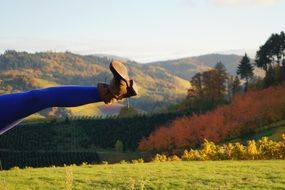 leg in a brown boot on a background of the countryside