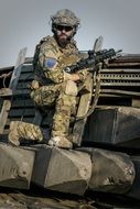 military with weapons on military equipment