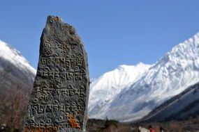 large stone with inscriptions in the Himalayas