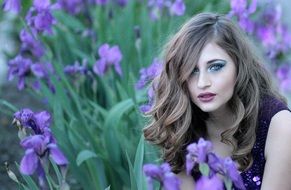 photo of the girl on a background of purple irises