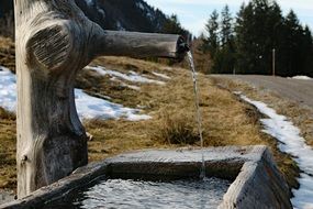 well water from a wooden tap