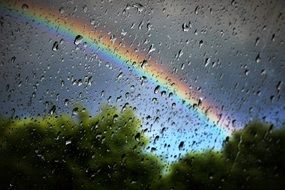 Rainbow and rain on the window