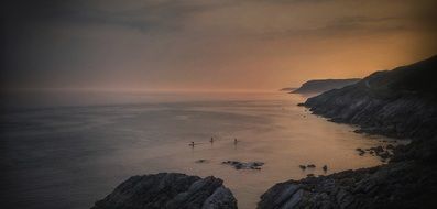 Paddleboarding exercise in evening ocean