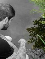 Pensive Man at the green Bush