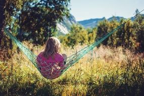 child Girl in hammock in view of Steigen Mountain, Norway