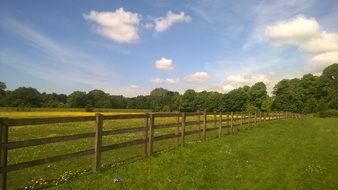 wooden fence on a green field