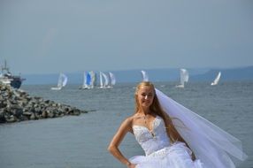 bride on the background of a yacht regatta