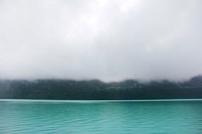 Mist above calm green Lake