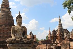 stone figure of a Buddha at a temple complex in thailand