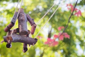 wooden figure man swinging on a swing