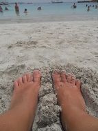 Feet on a sandy beach