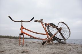 Broken bike on a beach