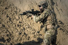 soldier with the gun in the desert