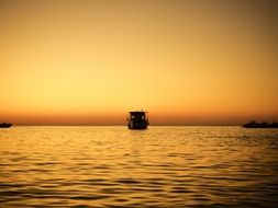 ship at sea during sunset