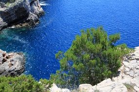 view from the cliff to the bright blue sea in Croatia