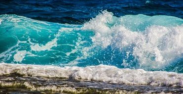 turquoise foam wave on the coast close up