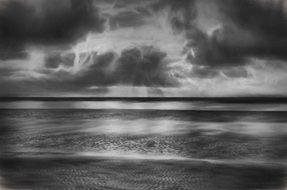 black and white photo of a beach near the north sea