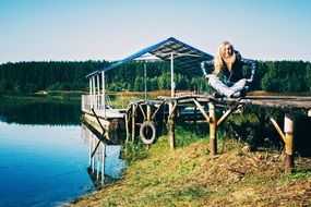 photo of a girl on a wooden pier by the river in Russia