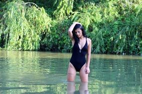 brunette in a black bathing suit in the water