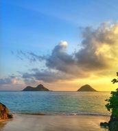 Beautiful and colorful sunset in clouds on the sandy beach in Hawaii