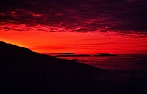 red sky over the mountain during sunset