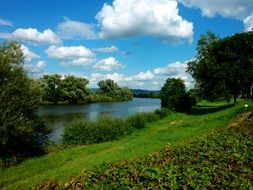 picturesque river with white clouds