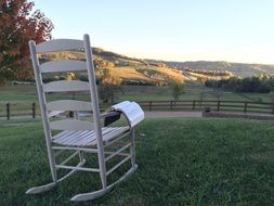 open bible on Chair at scenic rural landscape