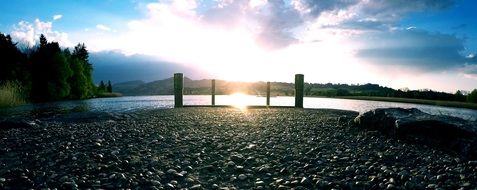 bright sun in the clouds over the lake