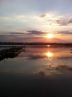 sunset in the clouds of the evening sky over the lake