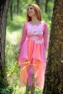 woman in fairy pink dress in the forest