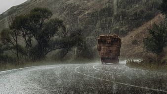 Truck on mountain road at rain