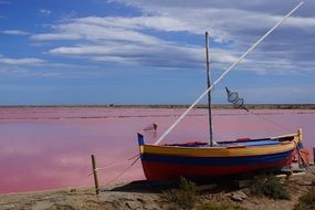 multi-colored fishing boat on the coast of France