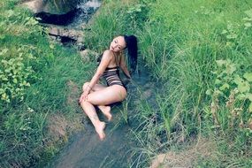 seductive model in swimsuit in the creek