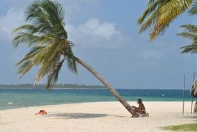 dark skin Woman sits on beach at Sea
