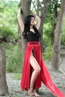 sensual brunette leaning on the tree