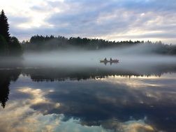 Kayak in the mist on the river Wieprza, Poland