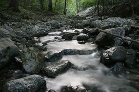 a stream flows over stones