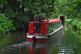 river tram on the water channel among dense thickets