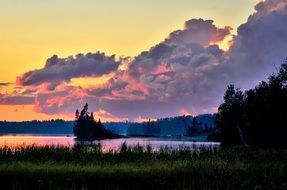 purple clouds over the lake at dusk