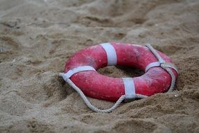 red life buoy on sand