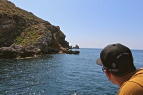 man on the water near the rocks