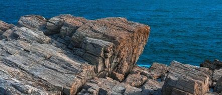 rocks on the shore of the blue sea in Canada