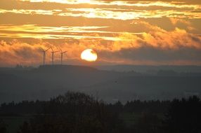 distant view of the wind turbines at sunset