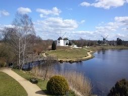 Landscape of the mill on a lake coast