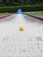 yellow ball on the mini golf ground