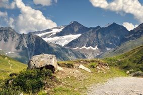 white clouds over the austrian alps on a sunny day