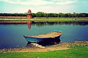 wooden boat on the banks of the jamuna river in india