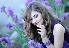 portrait of a blonde on purple iris flowers background