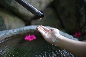 water in female Hand at fountain